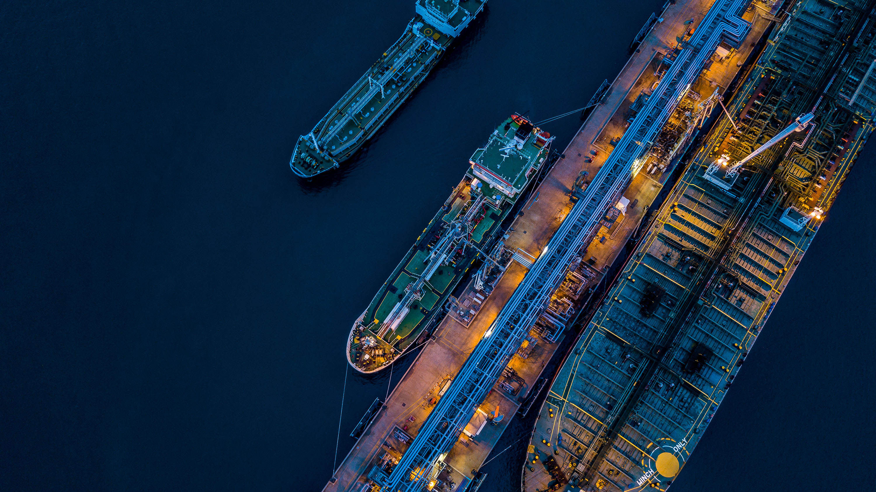 An aerial image of ships moored in a port at night
