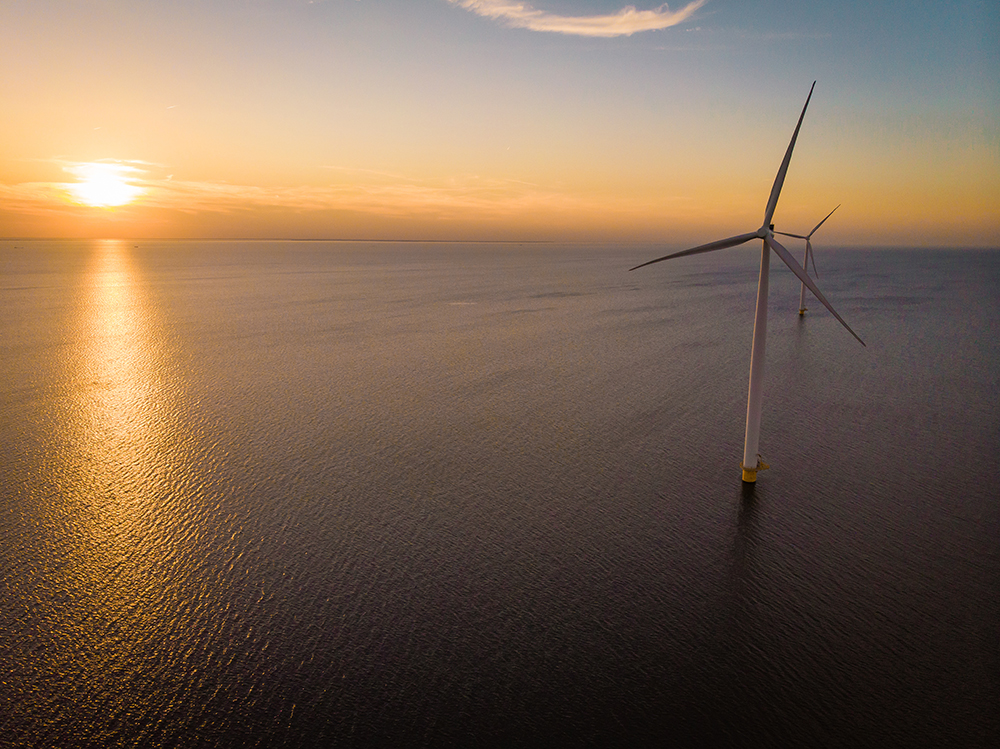 Offshore windfarm at sunset